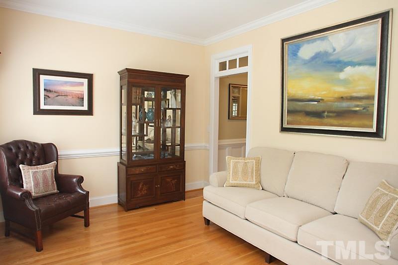 6725 Hammersmith Drive Raleigh, NC 27613 - Photo 3 of 17 a living room with furniture and painting on the wall