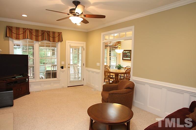 6725 Hammersmith Drive Raleigh, NC 27613 - Photo 8 of 17 a living room with furniture and a flat screen tv