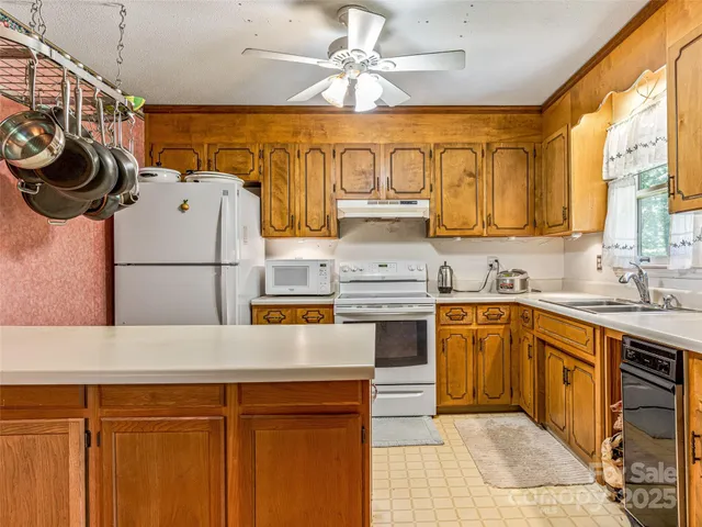 a kitchen with stainless steel appliances granite countertop a sink and cabinets