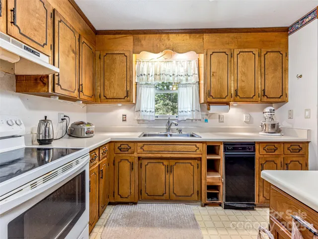 a kitchen with stainless steel appliances granite countertop a sink and cabinets