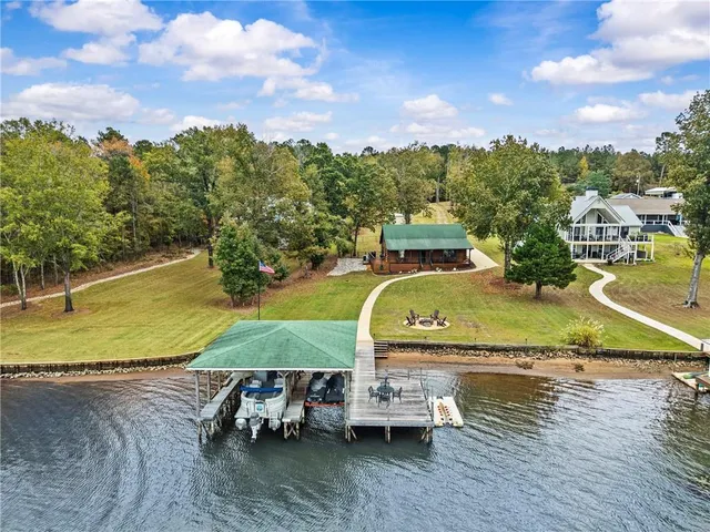 an aerial view of a house with outdoor space swimming pool and lake view