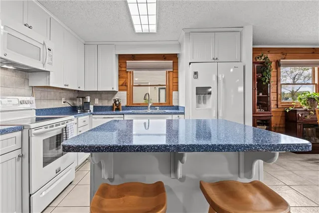a kitchen with stainless steel appliances granite countertop a stove a sink and a granite counter tops