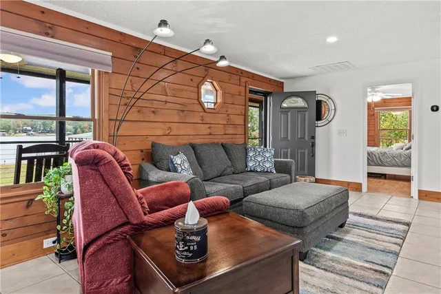 a living room with furniture and a floor to ceiling window