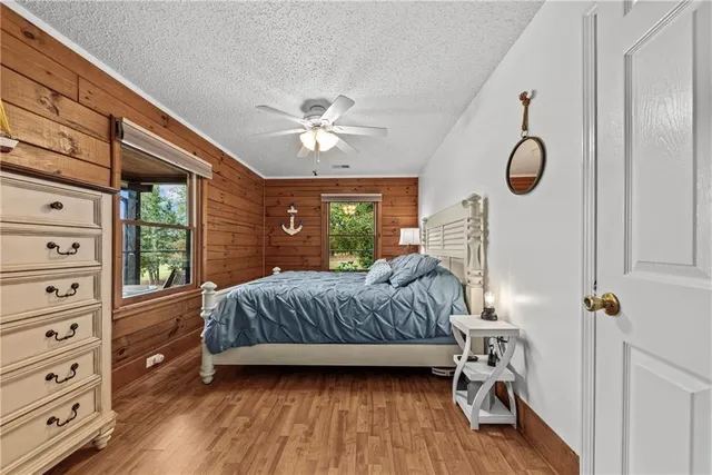 a bedroom with a large bed and a chandelier