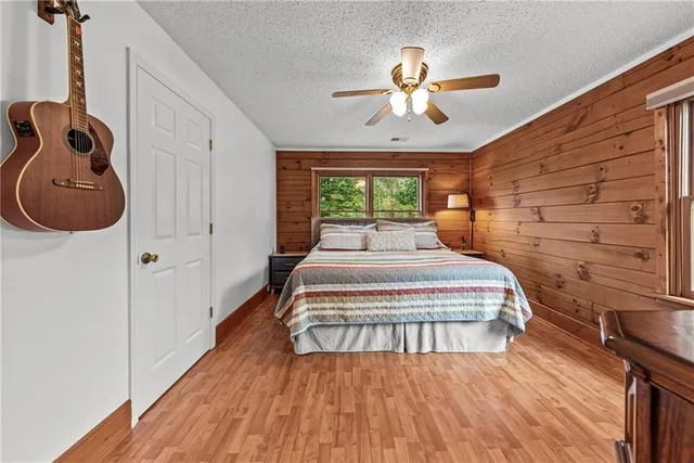 a bedroom with a bed a flat screen tv and a couch