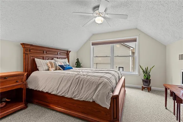 a bedroom with bed and a chandelier