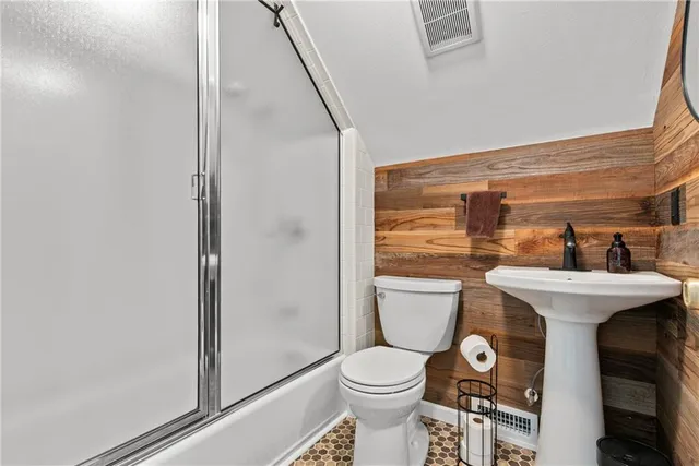 a spacious bedroom with a bed and a flat screen tv