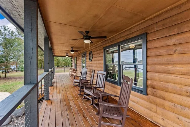 a view of balcony with chairs and wooden fence