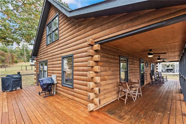 a view of a house with backyard and trees