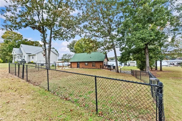 a view of a swimming pool with a yard and sitting area