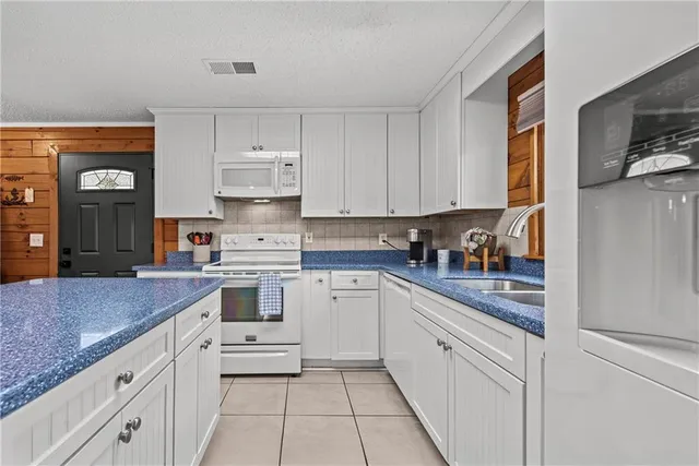 a kitchen with stainless steel appliances granite countertop a sink and cabinets