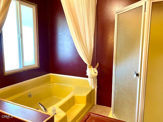 4140 Bradfield Drive, Unit 59 Oxnard, CA 93033 - Photo 15 of 19 a bathroom with a tub and shower