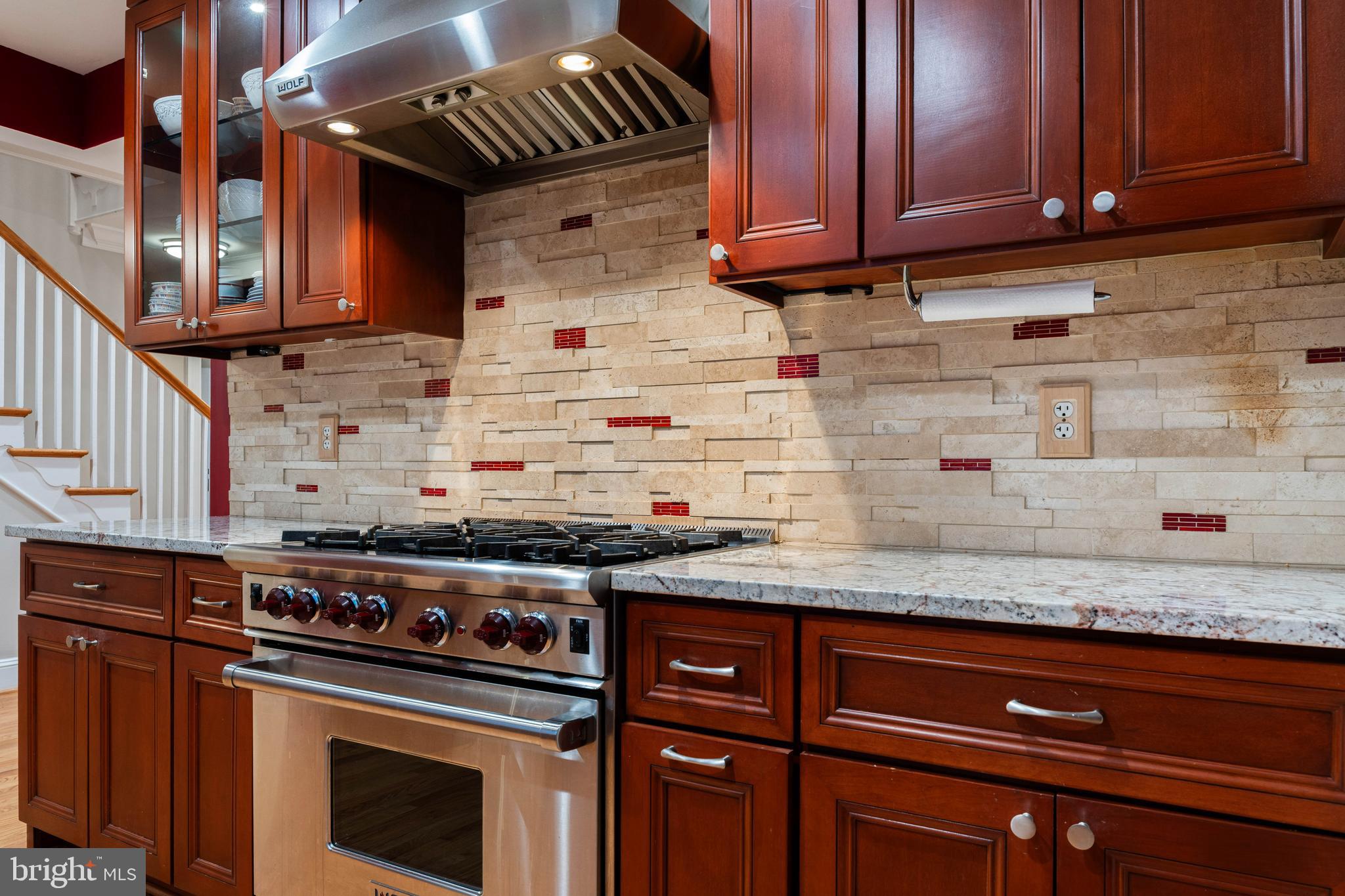 101 Thicket Road Baltimore, MD 21212 - Photo 16 of 30 a kitchen with granite countertop cabinets and a stove top oven