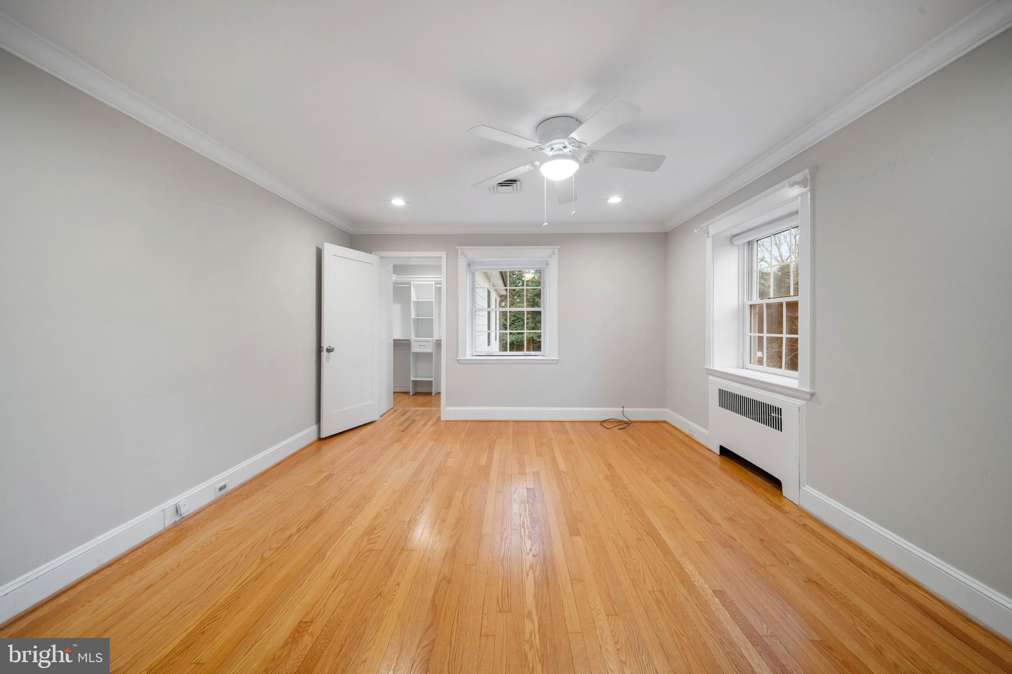101 Thicket Road Baltimore, MD 21212 - Photo 21 of 30 a view of an empty room with wooden floor and a window