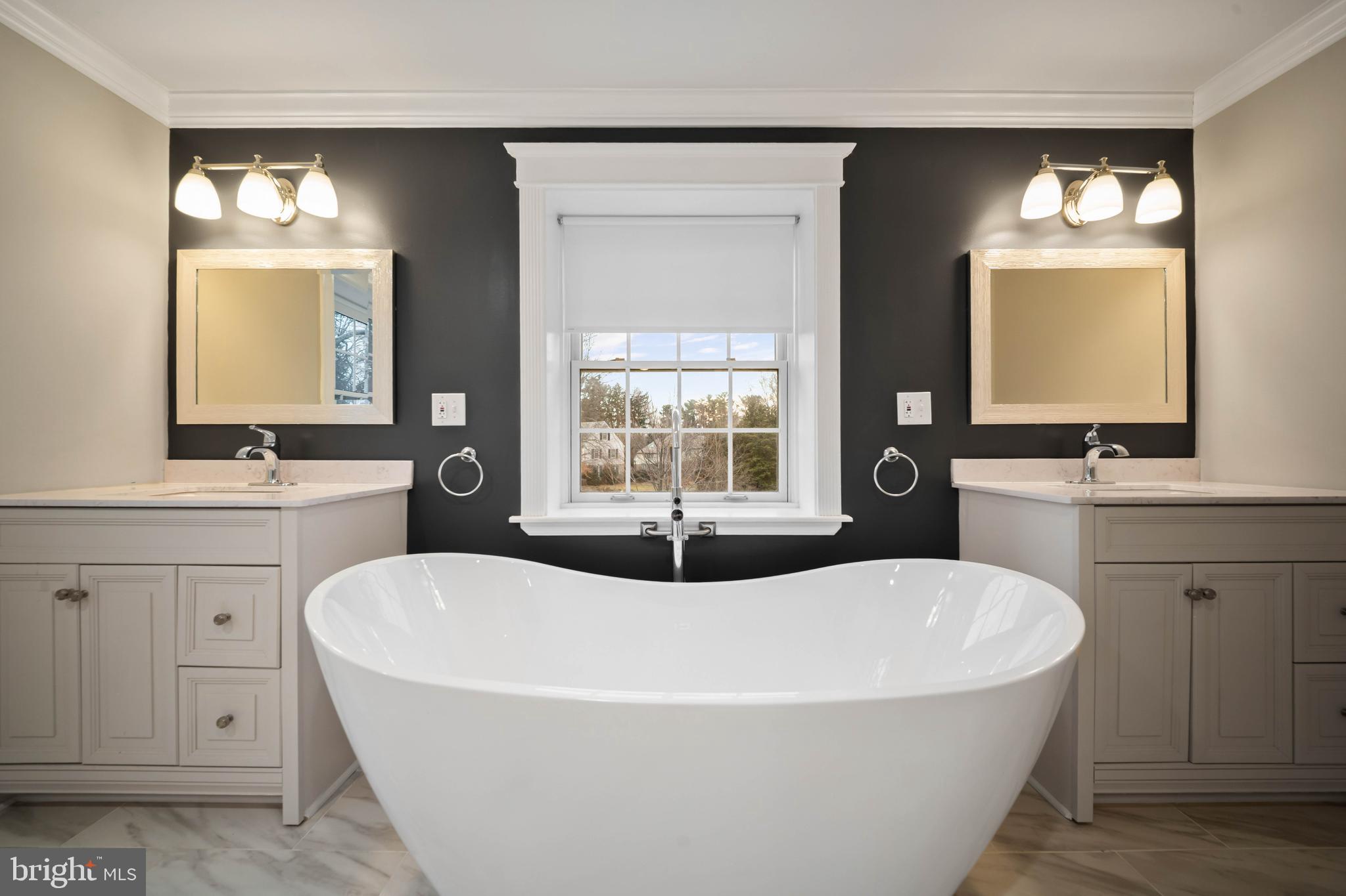 101 Thicket Road Baltimore, MD 21212 - Photo 23 of 30 a white bath tub sitting in a bathroom and mirror