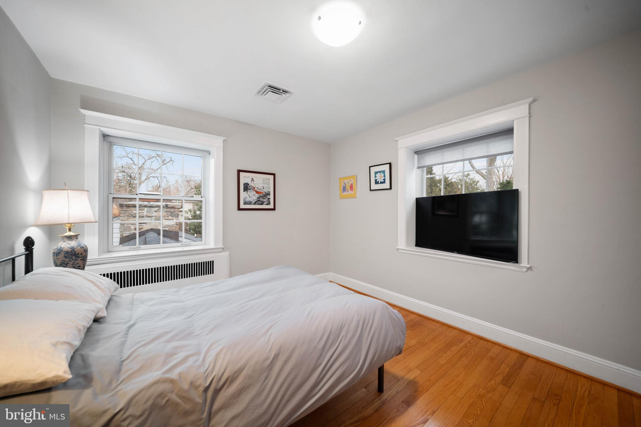 101 Thicket Road Baltimore, MD 21212 - Photo 25 of 30 a bedroom with a bed and a flat screen tv