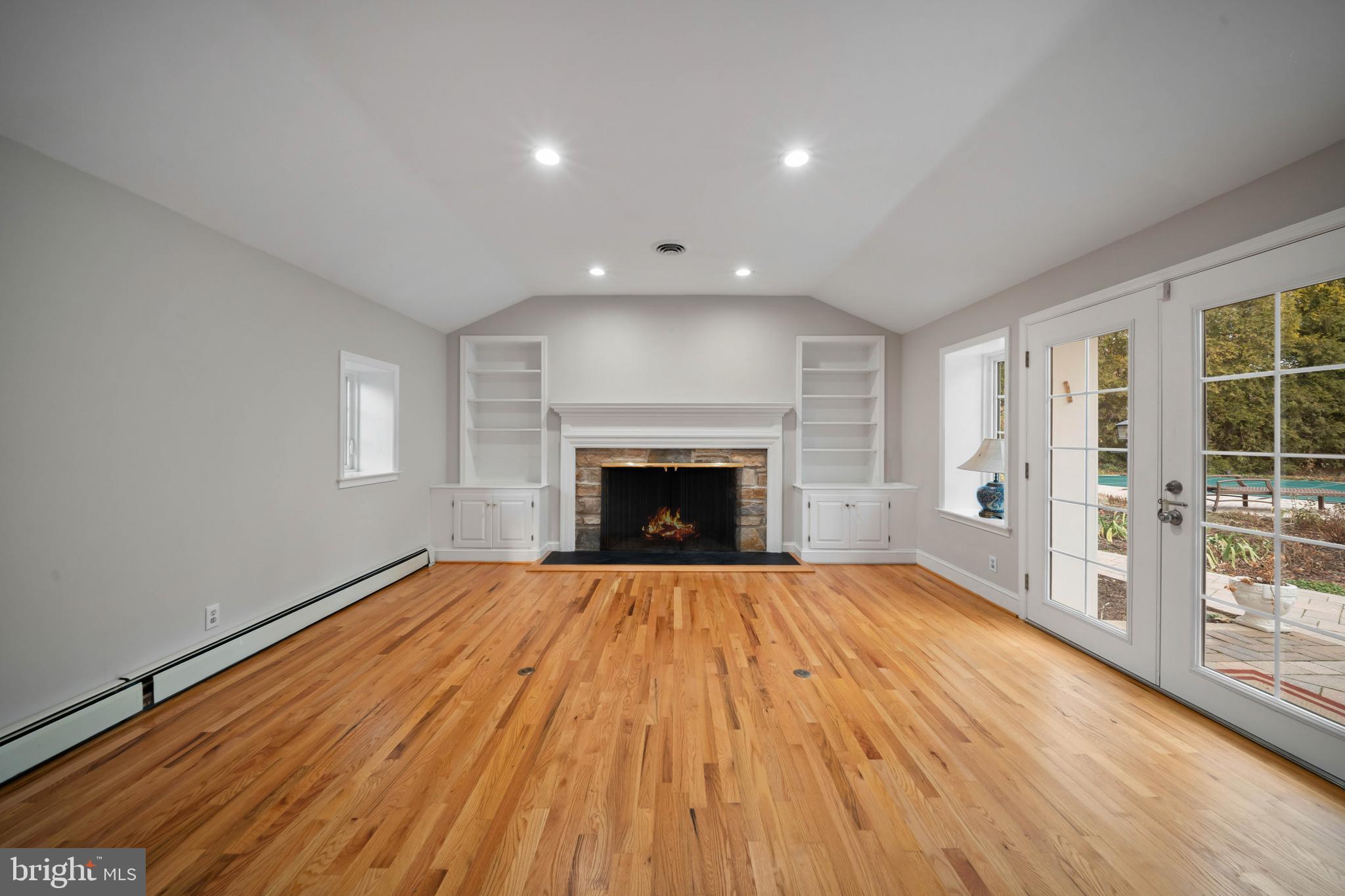 101 Thicket Road Baltimore, MD 21212 - Photo 5 of 30 a view of an empty room with wooden floor and a window