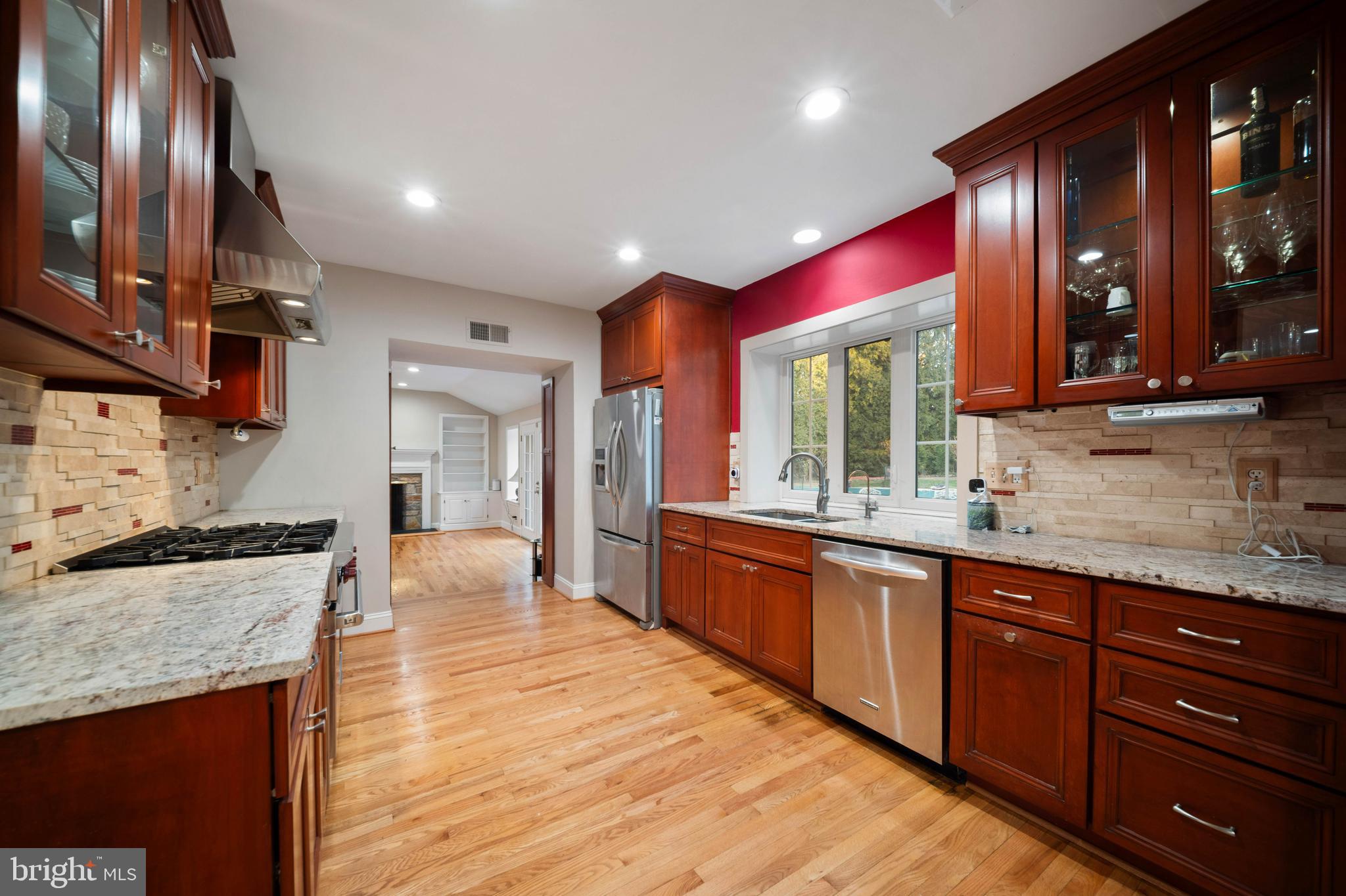 101 Thicket Road Baltimore, MD 21212 - Photo 6 of 30 a large kitchen with stainless steel appliances granite countertop wooden cabinets a oven and granite counter tops with a large window