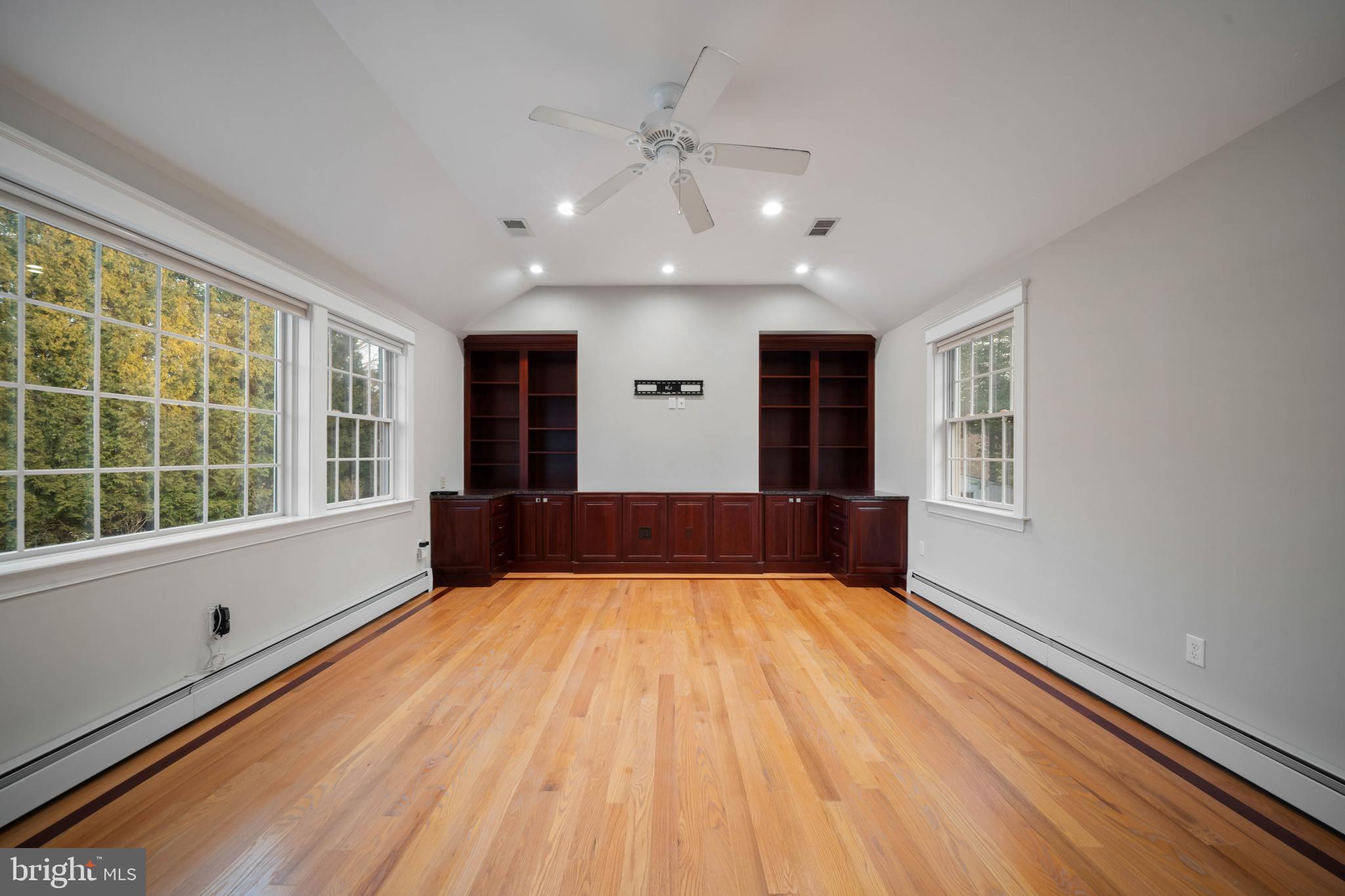 101 Thicket Road Baltimore, MD 21212 - Photo 10 of 30 a view of an empty room with a window and wooden floor