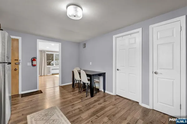 a view of a dining room with furniture and wooden floor