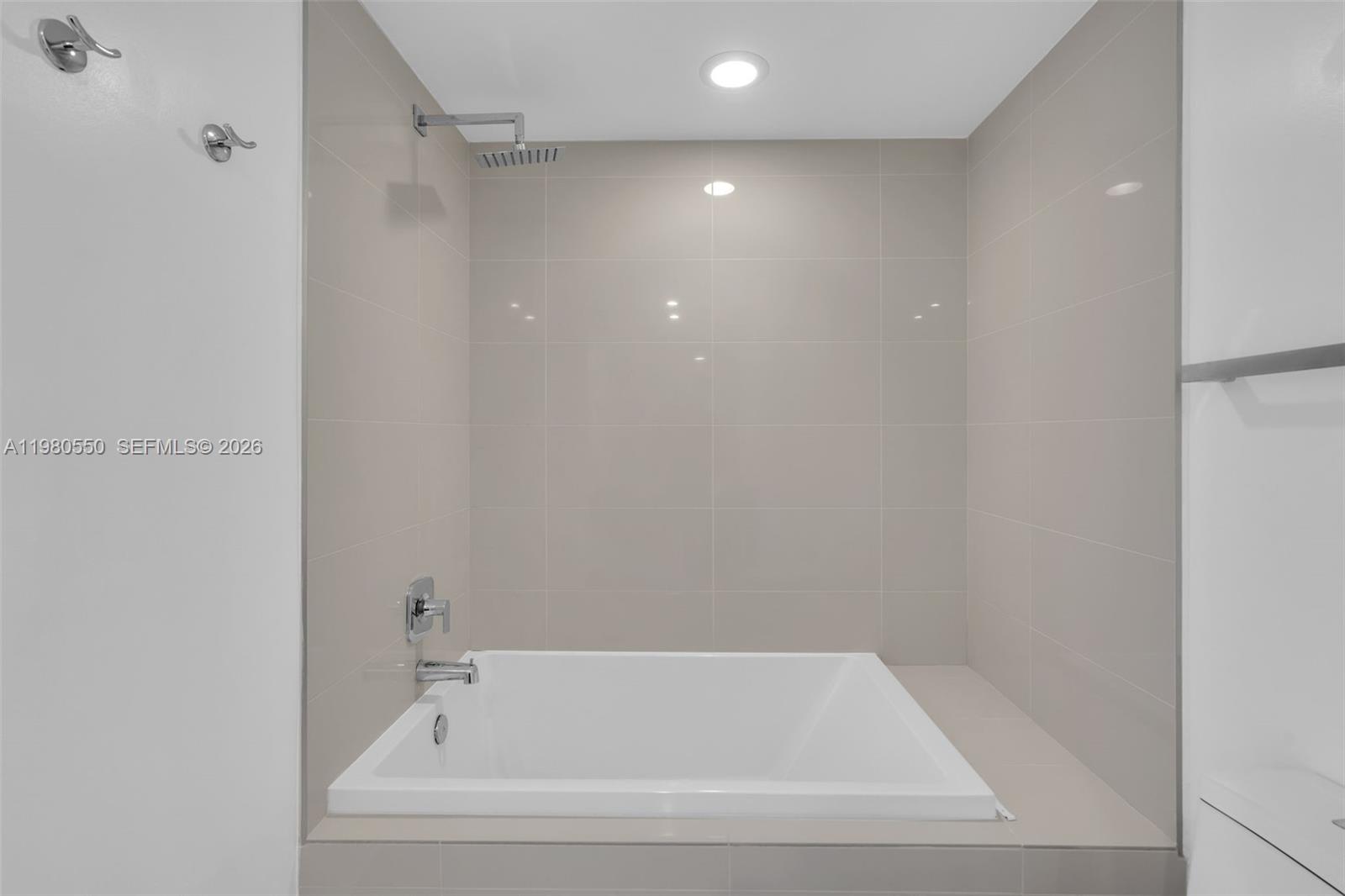 55 Southwest 9th Street, Unit 1109 Miami, FL 33130 - Photo 20 of 35 a white bath tub sitting in a bathroom