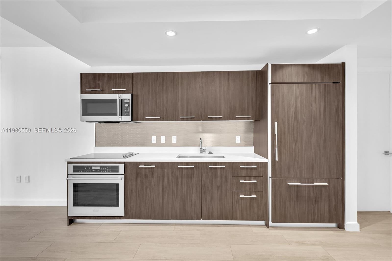 55 Southwest 9th Street, Unit 1109 Miami, FL 33130 - Photo 8 of 35 a kitchen with a stove and a sink