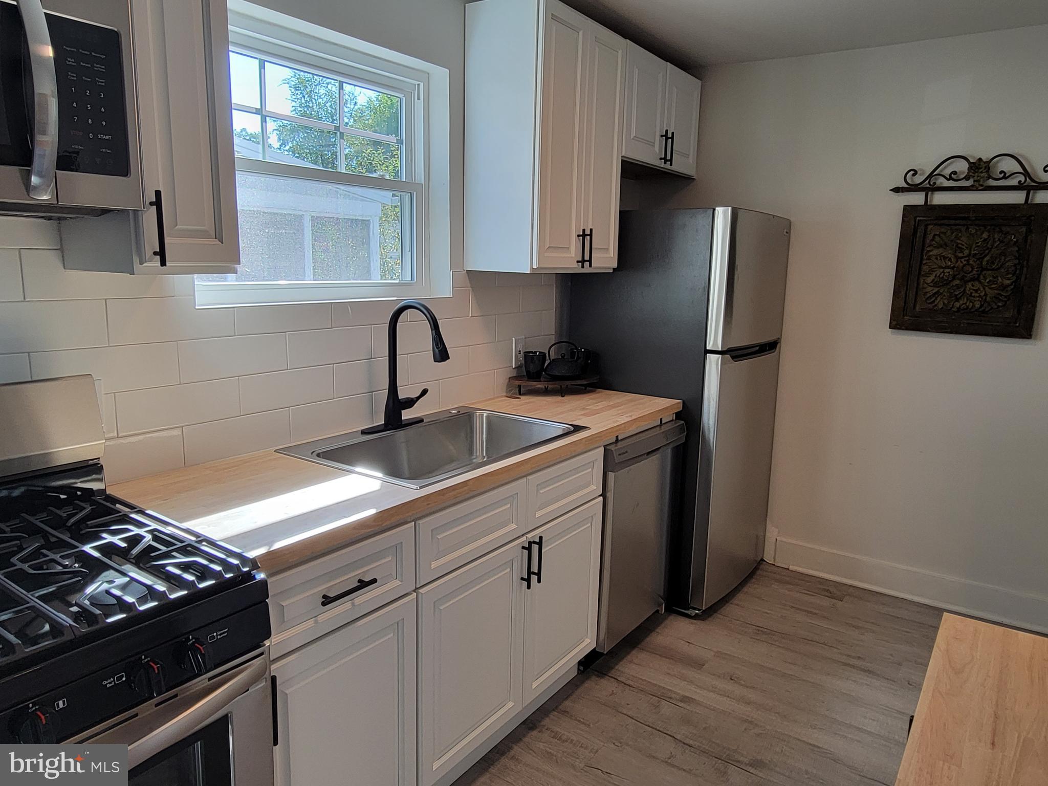 536 Crotzer Avenue Folcroft, PA 19032 - Photo 7 of 35 a kitchen with stainless steel appliances a sink stove and refrigerator