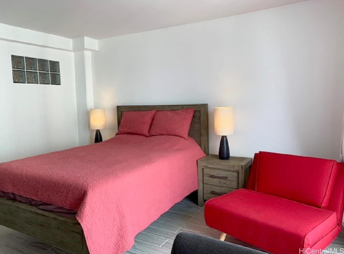 1920 Ala Moana Boulevard, Unit 2006 Honolulu, HI 96815 - Photo 3 of 7 a bedroom with a bed and a couch