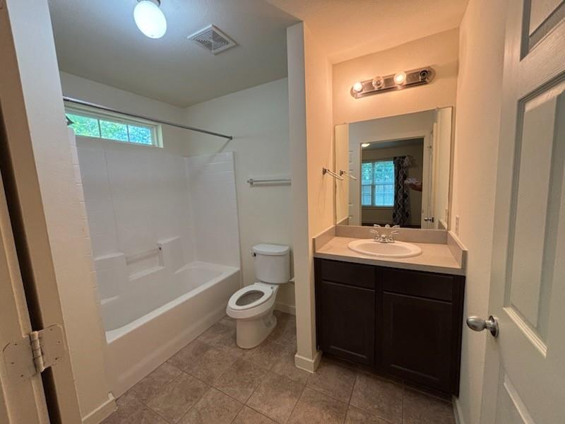 4744 Stokes Street Dallas, TX 75216 - Photo 13 of 20 a bathroom with a granite countertop sink mirror bathtub and toilet