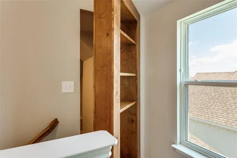a bathroom with a toilet a sink and a window