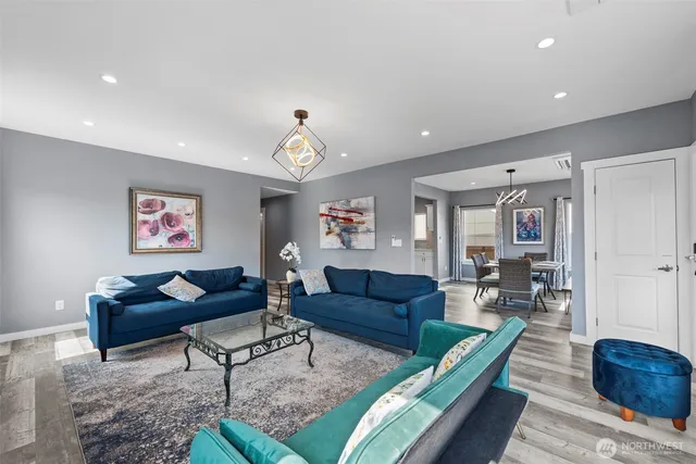 a living room with furniture a fireplace and a chandelier