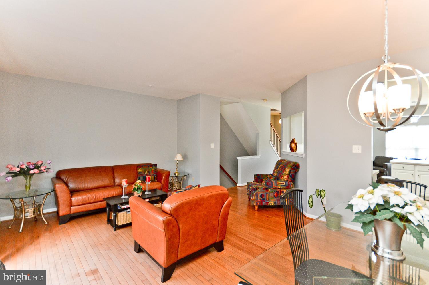 1113 Ring Bill Loop Upper Marlboro, MD 20774 - Photo 14 of 39 a living room with furniture a fireplace and a chandelier
