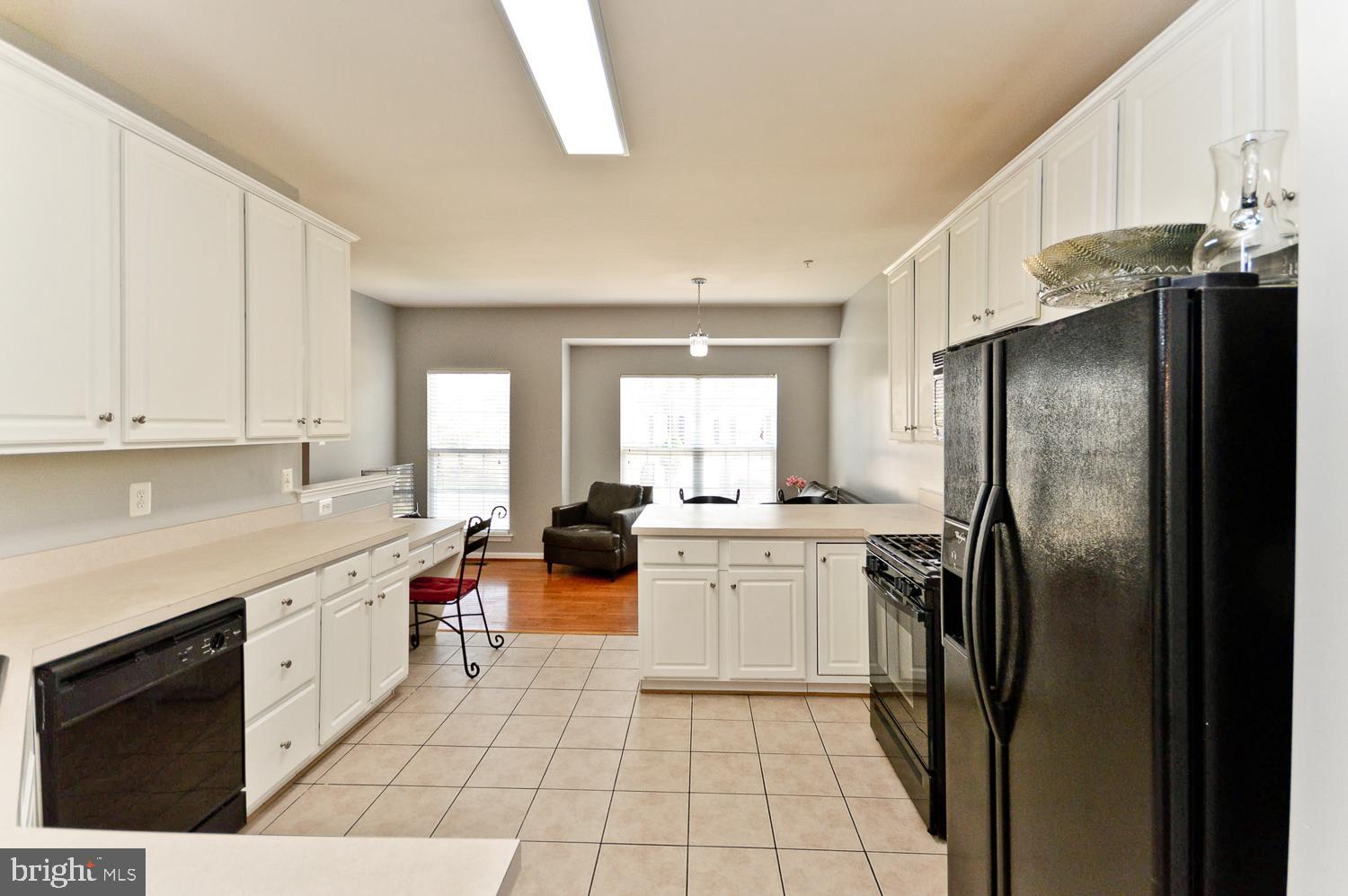 1113 Ring Bill Loop Upper Marlboro, MD 20774 - Photo 16 of 39 a kitchen with stainless steel appliances a refrigerator sink and cabinets
