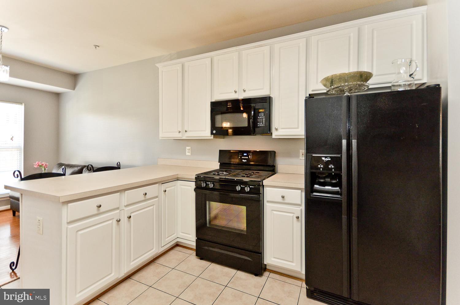 1113 Ring Bill Loop Upper Marlboro, MD 20774 - Photo 18 of 39 a kitchen with granite countertop white cabinets and stainless steel appliances