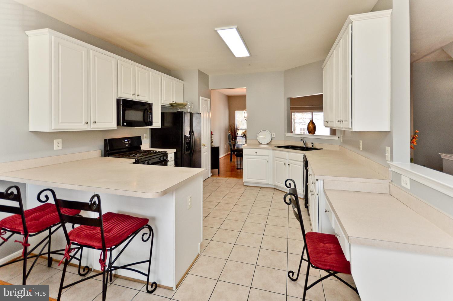 1113 Ring Bill Loop Upper Marlboro, MD 20774 - Photo 19 of 39 a kitchen with stainless steel appliances a stove a sink a microwave and a refrigerator