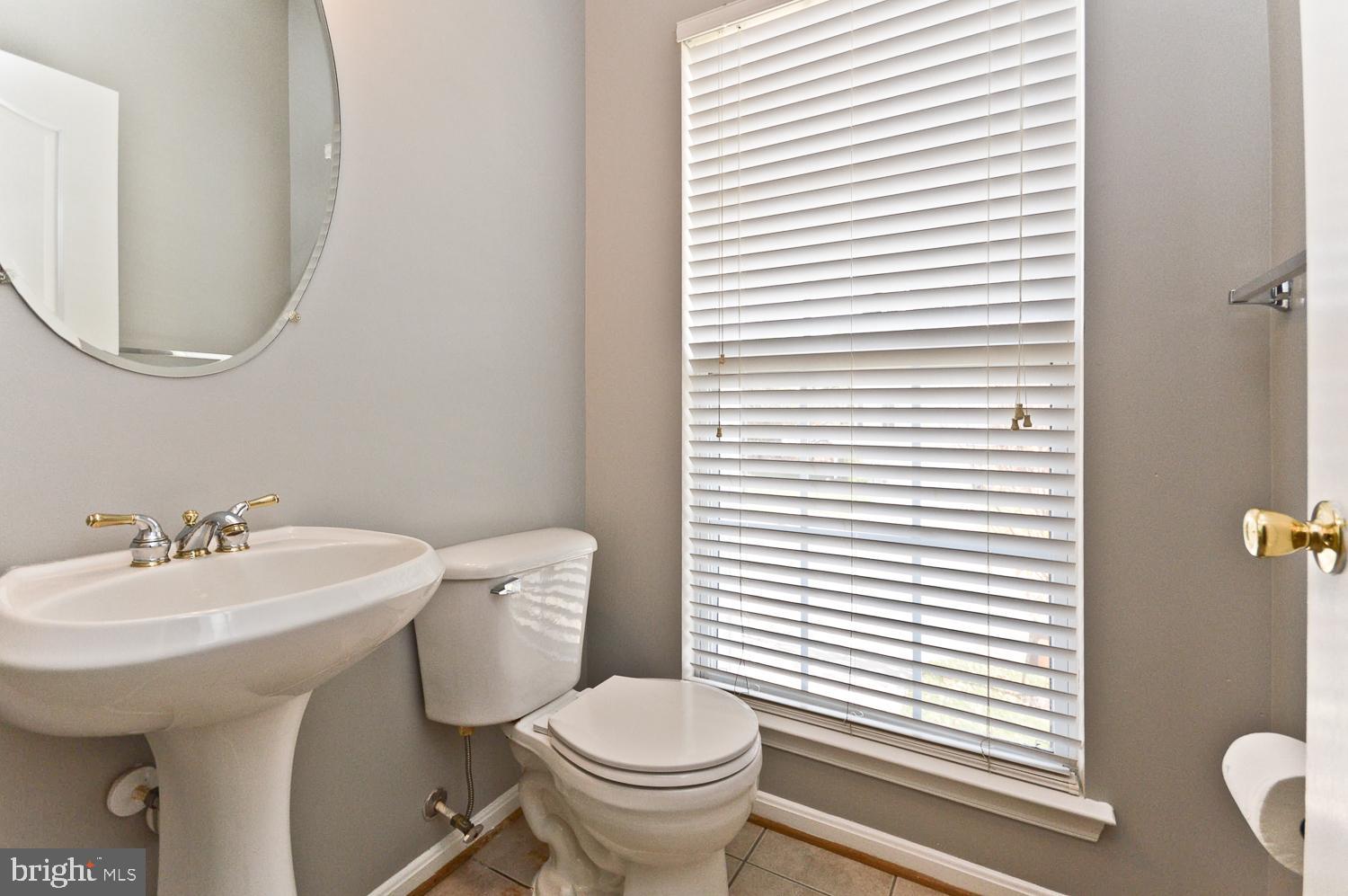 1113 Ring Bill Loop Upper Marlboro, MD 20774 - Photo 22 of 39 a bathroom with a sink a toilet and a mirror
