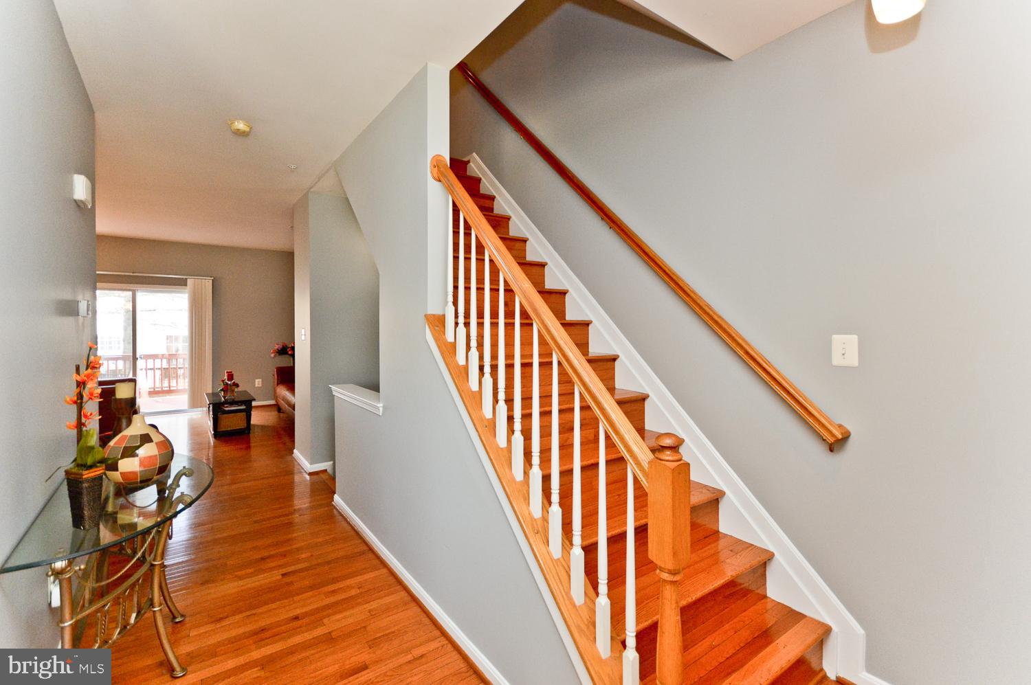 1113 Ring Bill Loop Upper Marlboro, MD 20774 - Photo 23 of 39 a view of a hallway with wooden floor and stairs