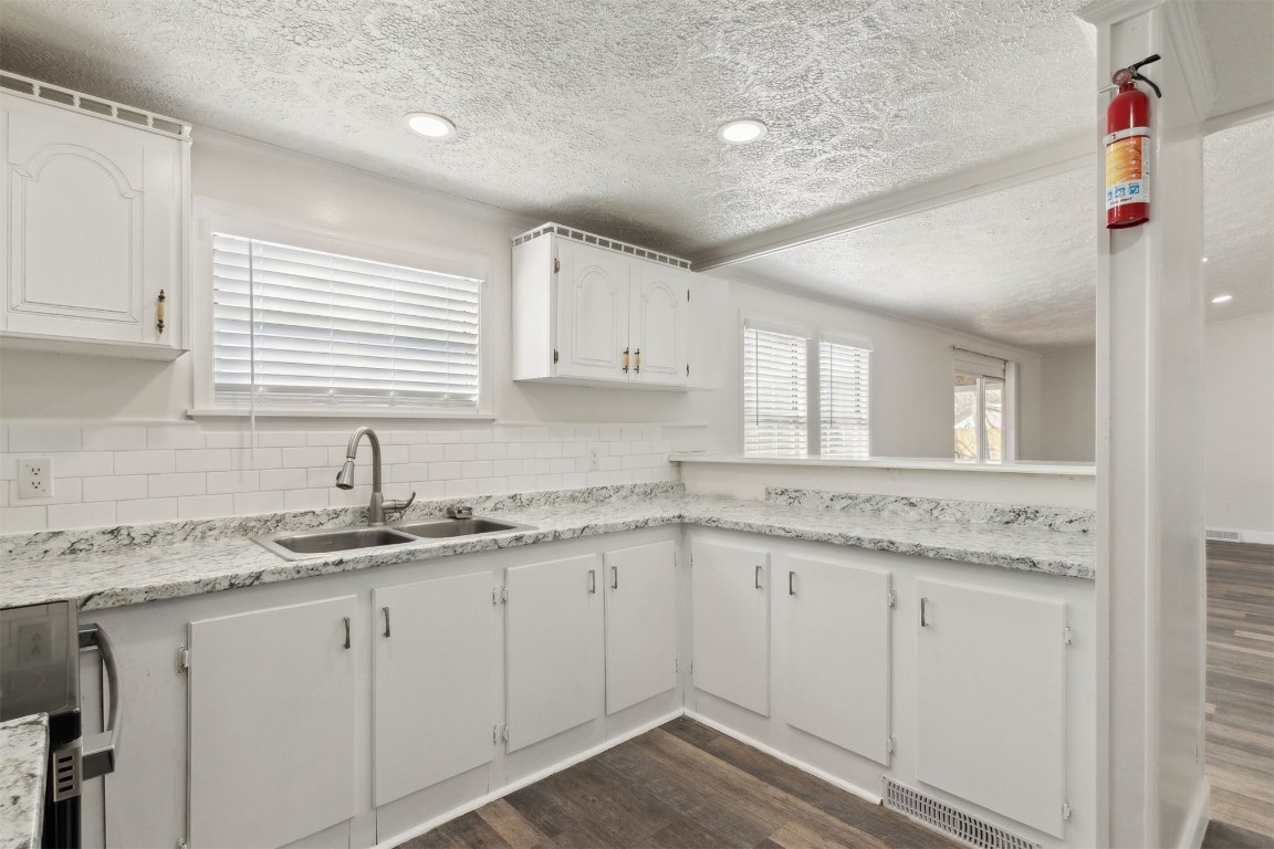 97119 Diamond Street Yulee, FL 32097 - Photo 11 of 23 a kitchen with granite countertop white cabinets and white appliances