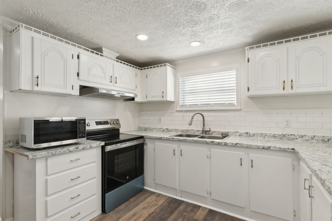 97119 Diamond Street Yulee, FL 32097 - Photo 10 of 23 a kitchen with cabinets appliances a sink and a window
