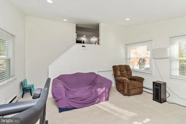 a bedroom with a bed a window and chair