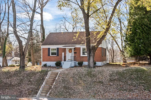 a view of a house with a yard covered in snow