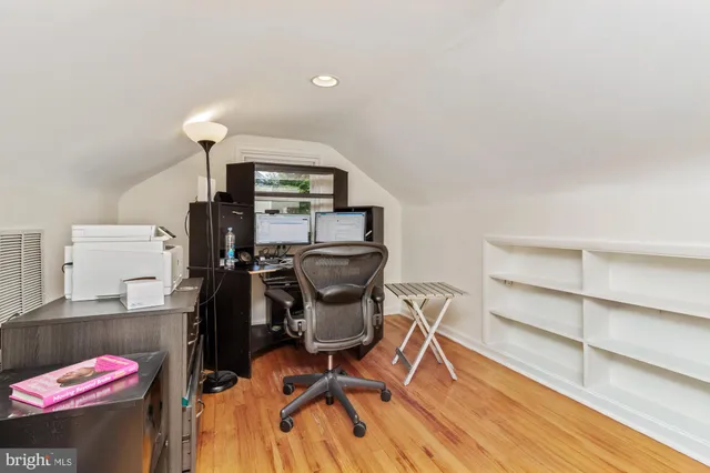 a bedroom with a bed and a book shelf