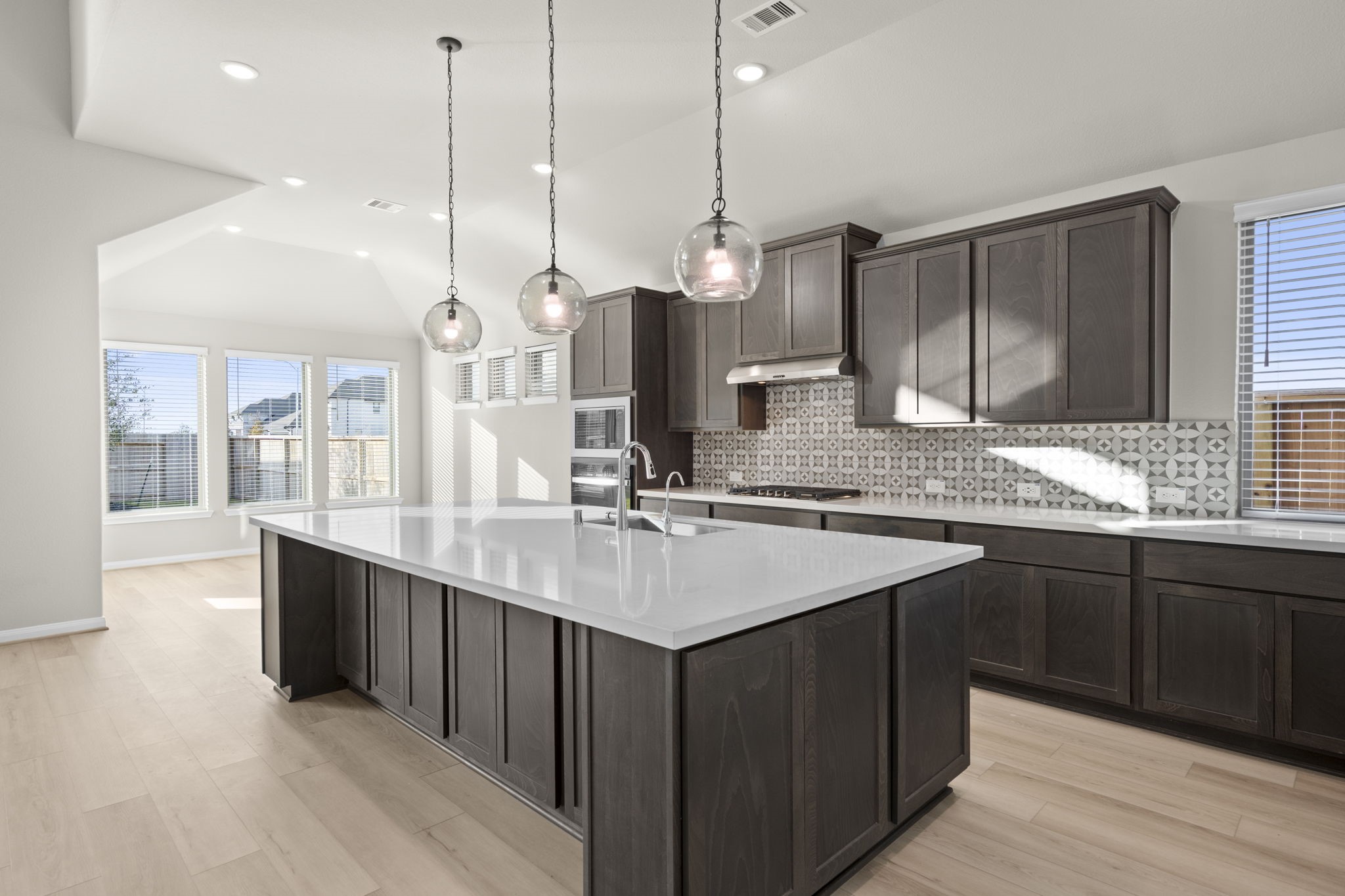 6402 Citron Elm Road Manvel, TX 77578 - Photo 4 of 37 a kitchen with a sink stove and wooden floor