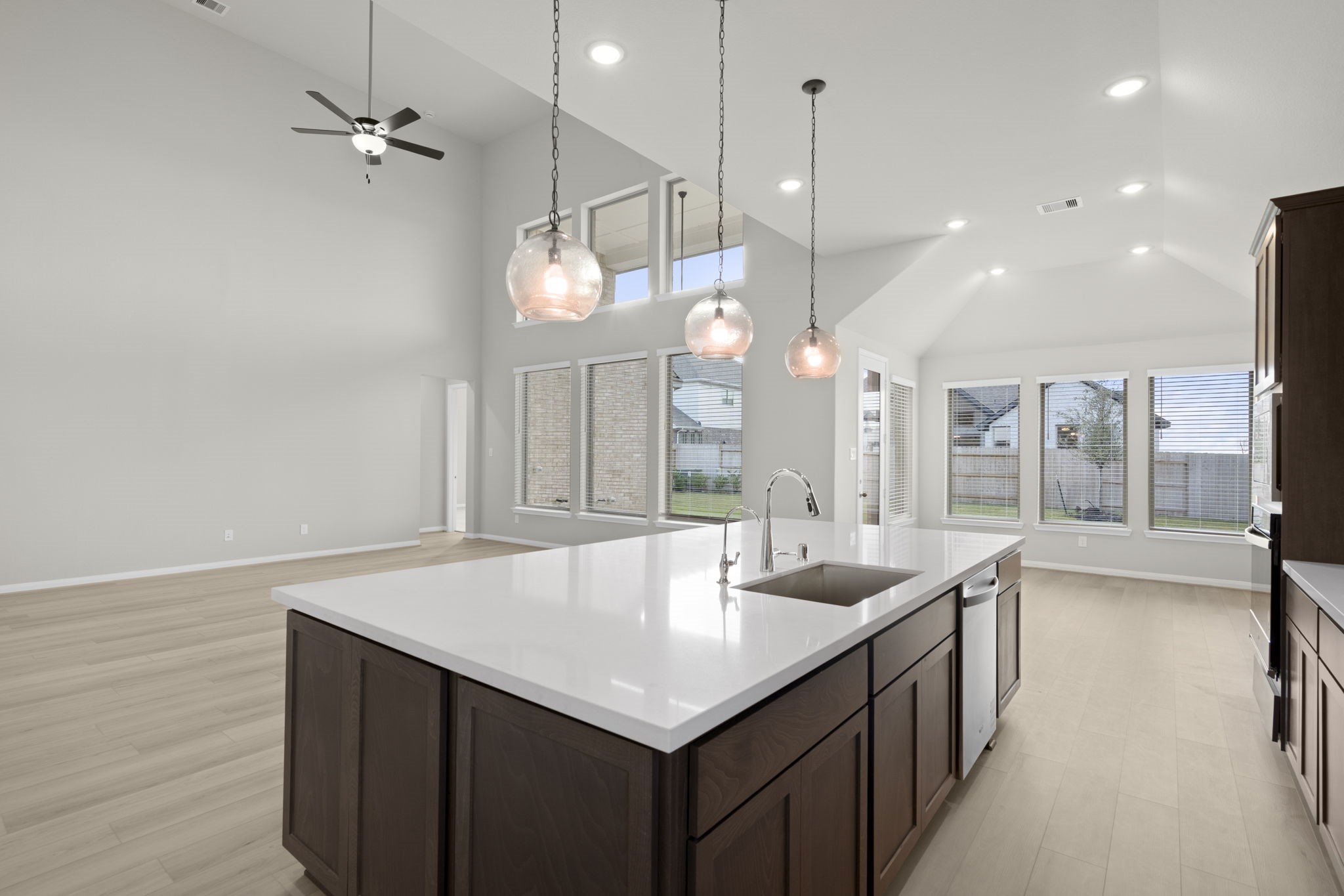 6402 Citron Elm Road Manvel, TX 77578 - Photo 8 of 37 an open kitchen with a sink dishwasher and a stove with wooden floor