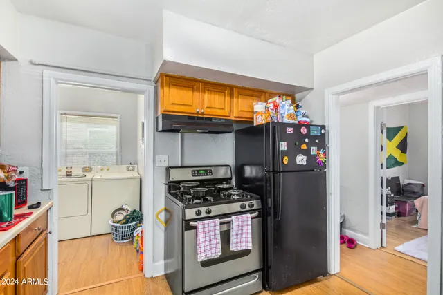 a kitchen with stainless steel appliances granite countertop a stove and a refrigerator