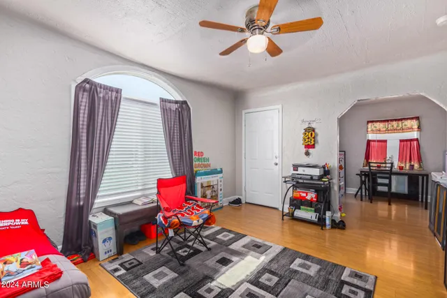 a living room with furniture and a wooden floor
