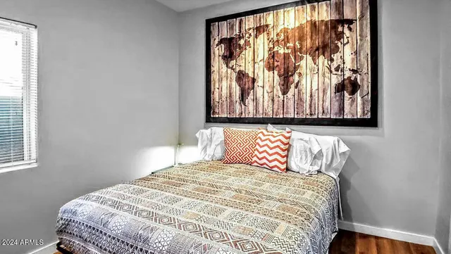 a bedroom with a bed and a window