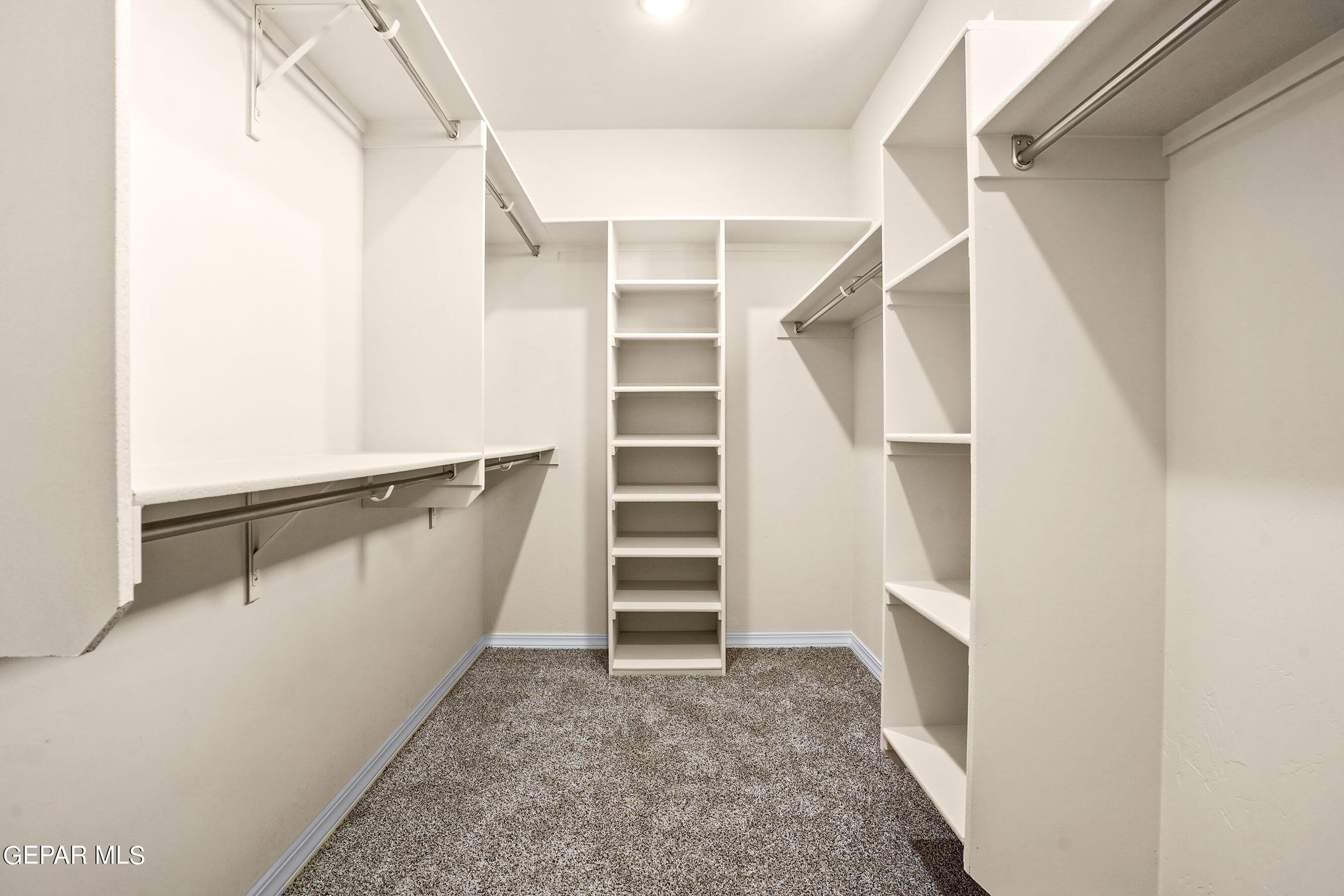 871 Country Club Road, Unit 4E El Paso, TX 79932 - Photo 7 of 34 a view of walk in closet with empty racks