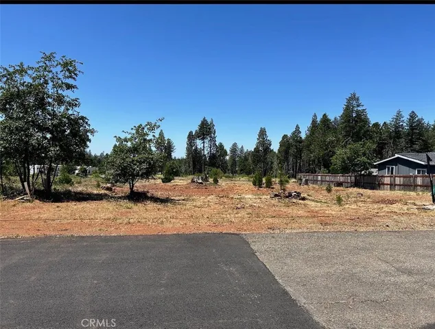 a view of a dirt road with a building in the background