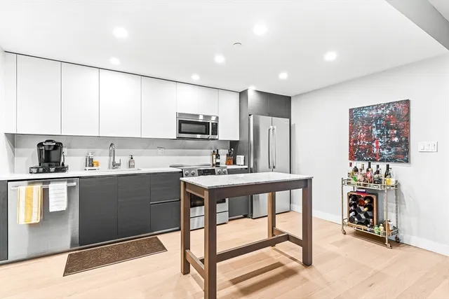 a kitchen with stainless steel appliances granite countertop a refrigerator sink and cabinets